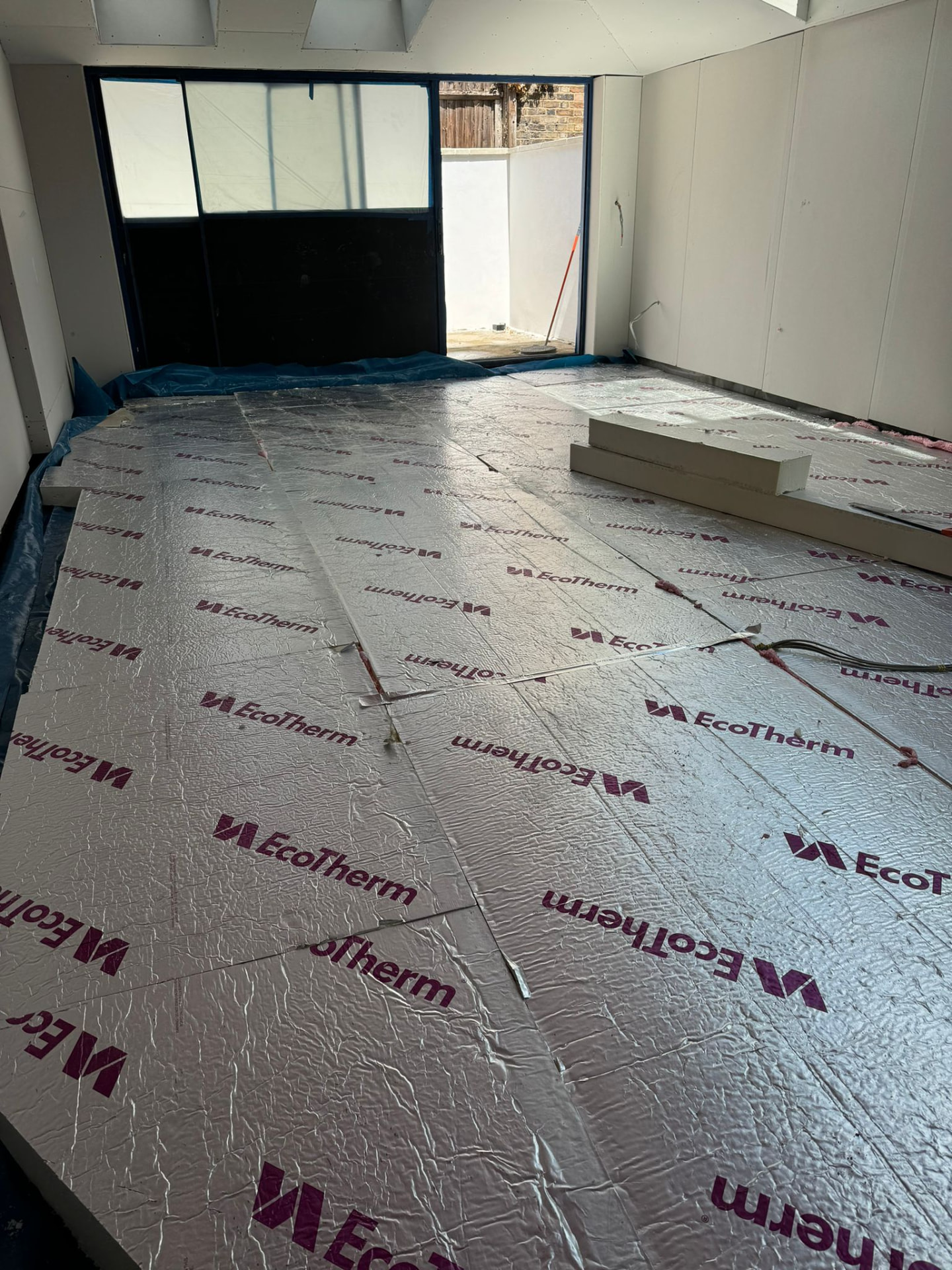 Insulation boards laid across the ground floor before screed