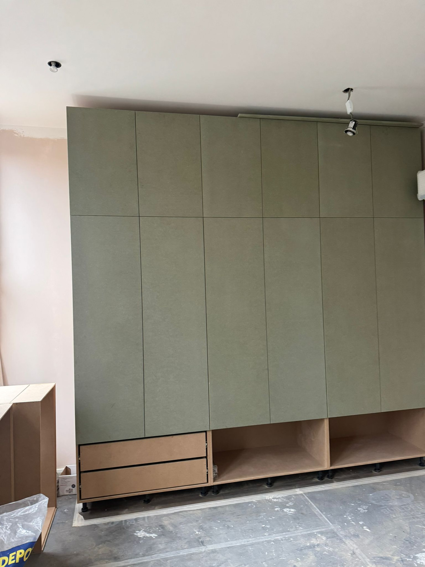 Bespoke floor-to-ceiling handleless joinery before final paint finish